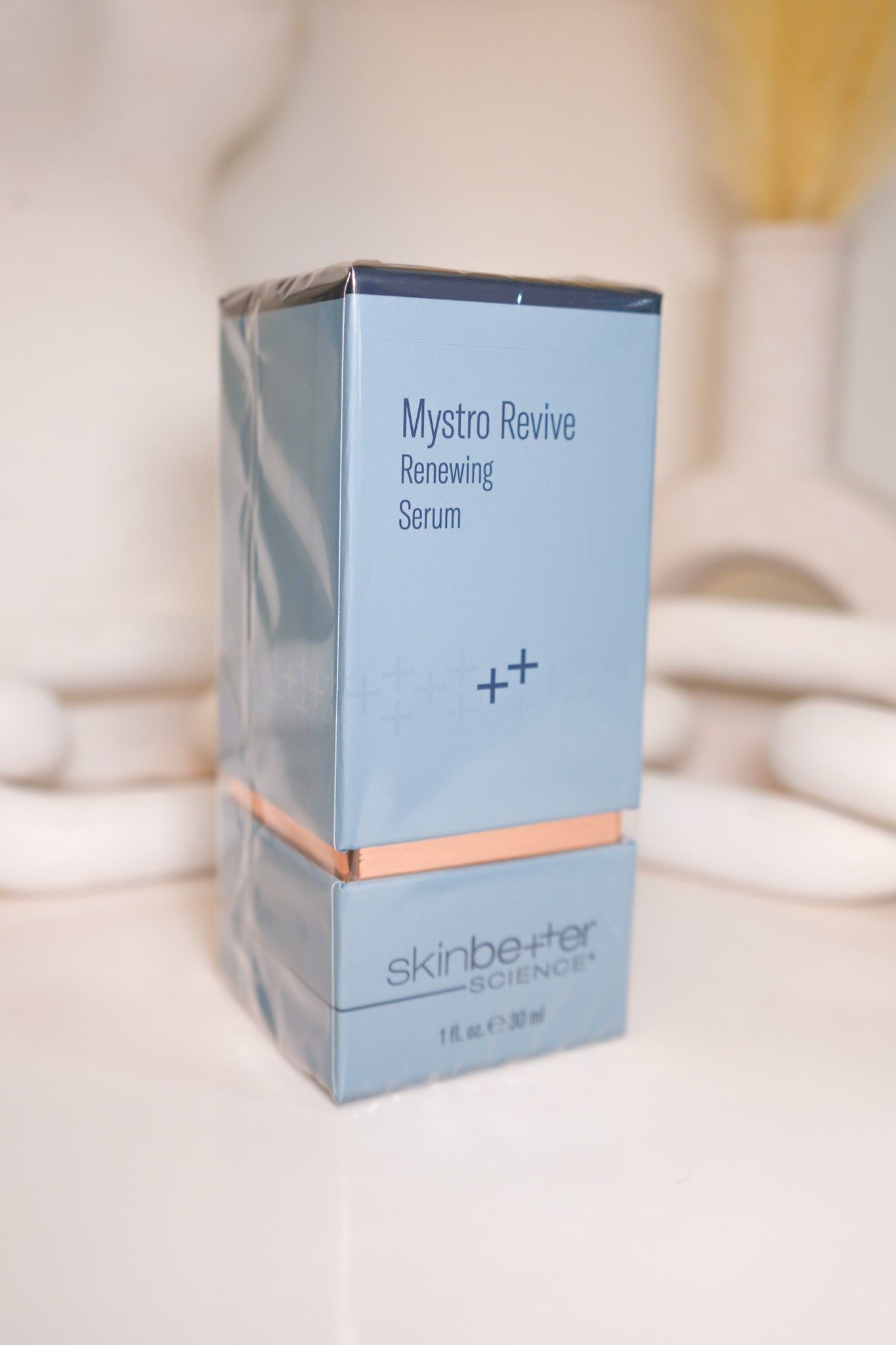 Mystro Revive Renewing Serum packaging on a blurred background